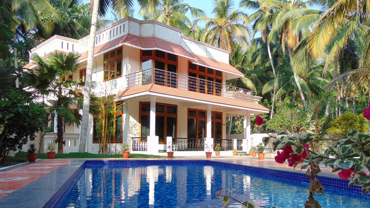 Large villa-style home set among tropical trees